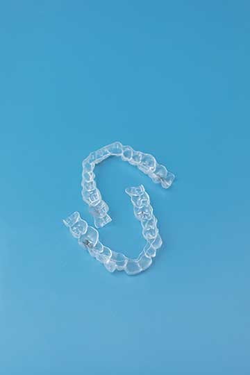 Clear orthodontic aligners shown close-up for Invisalign cost overview