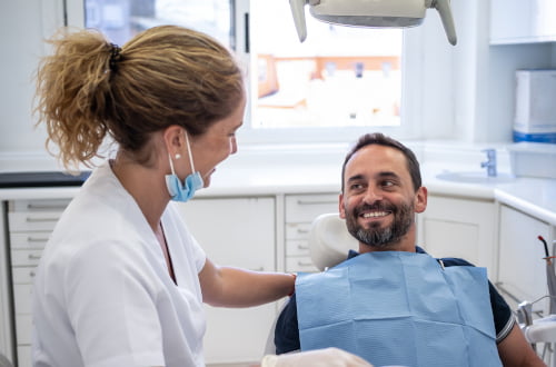 Patient smiling during a preventive dental check-up at a clinic accepting the Canadian Dental Care Plan.